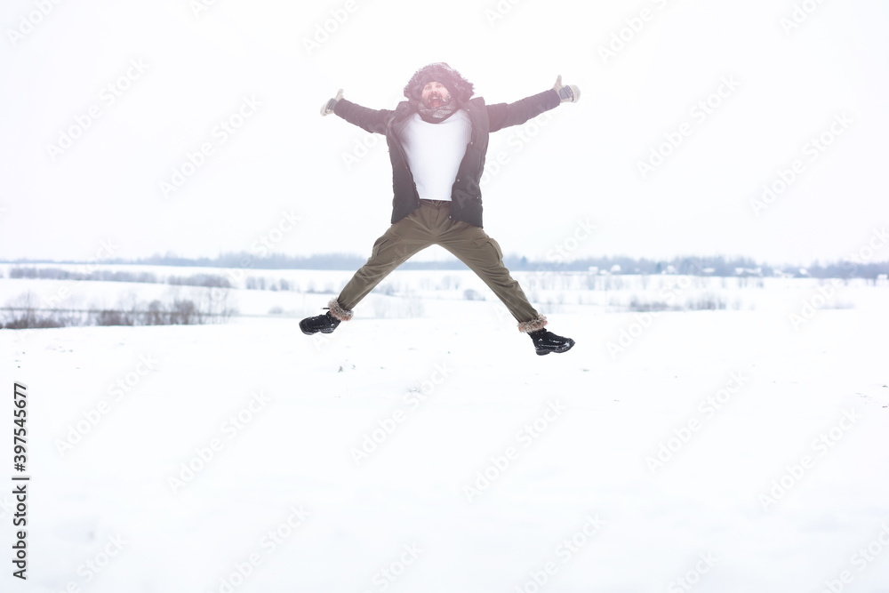 Outdoor portrait of handsome man in coat and scurf. Bearded man in the winter woods. Outdoor portrait of handsome man in coat and scurf. Bearded man in the winter woods.