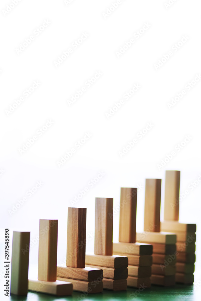 Stick wood block standing on stacked square wood blocks, abstract background in concept of winning, success, challenge, step to top position. Stick wood block standing on stacked square wood blocks, abstract background in concept of winning, success, challenge, step to top position.