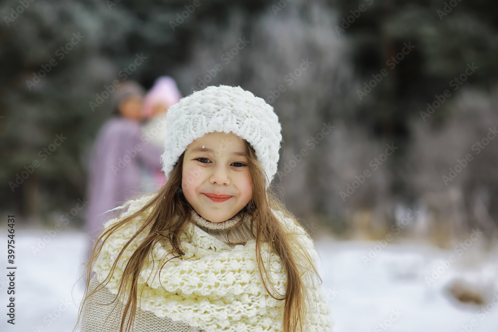 Happy family playing and laughing in winter outdoors in the snow. City park winter day.