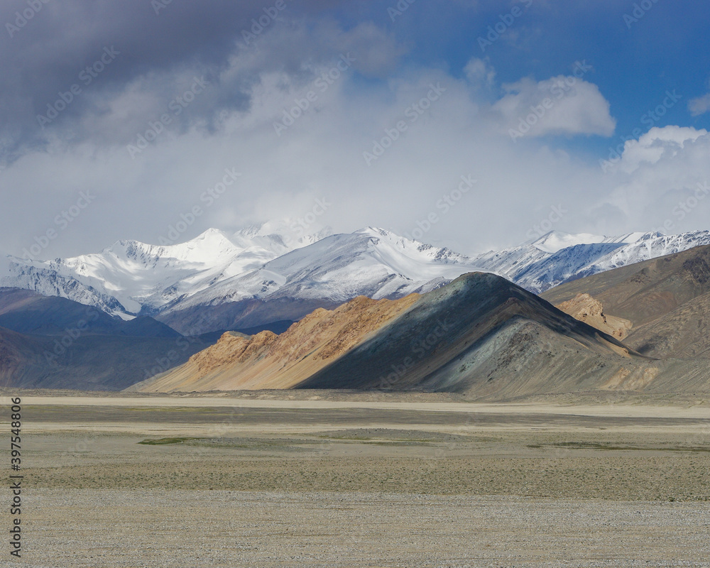 Stunning snow-capped mountains and pastel colors on the high-altitude Pamir Highway between Karakul and Kyzyl Art pass, Murghab district, Gorno-Badakshan region, Tajikistan Stunning snow-capped mountains and pastel colors on the high-altitude Pamir Highway between Karakul and Kyzyl Art pass, Murghab district, Gorno-Badakshan region, Tajikistan