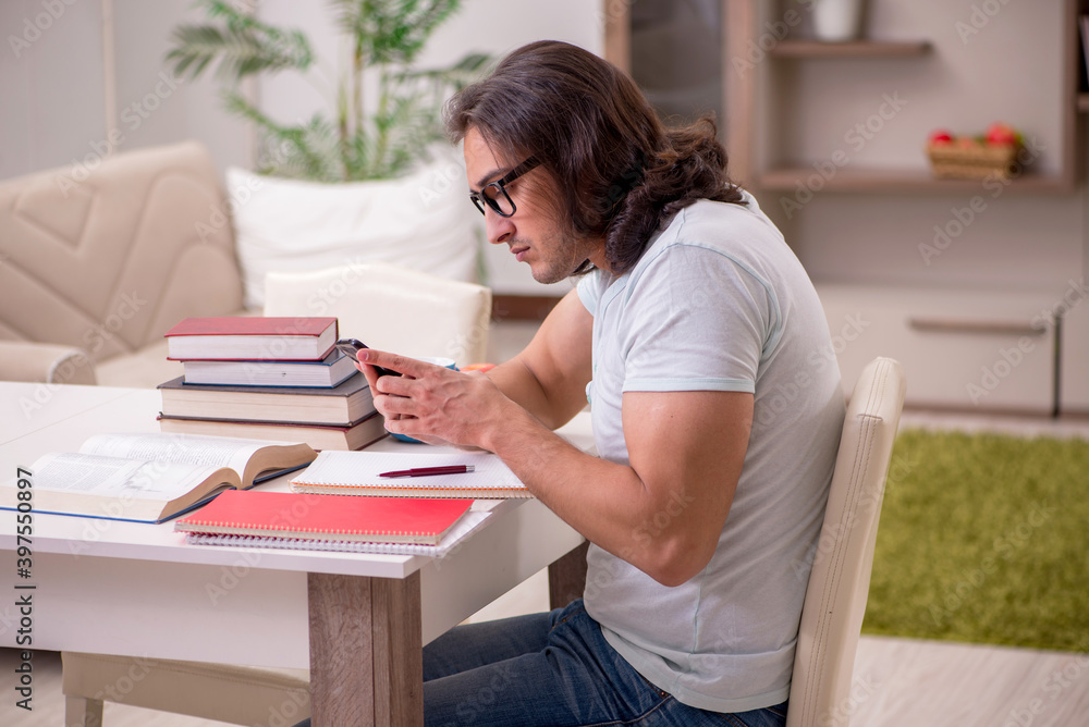 Young male student preparing for exams at home Young male student preparing for exams at home
