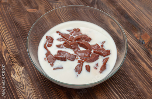 Beef liver soaked in milk in a glass bowl. Recipe