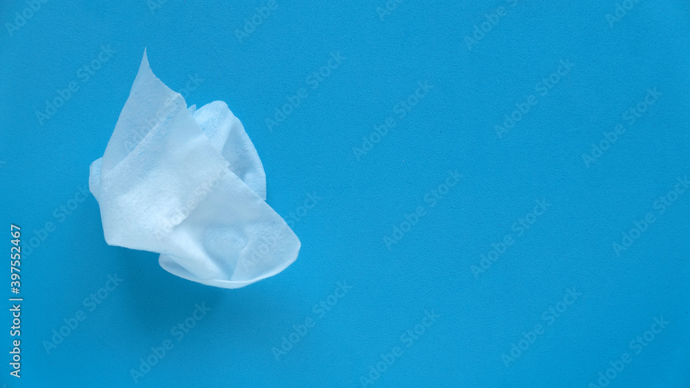Top view of wet tissue isolated on a blue background with copy space. Top view of wet tissue isolated on a blue background with copy space.