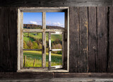 view through a wooden window into the landscape