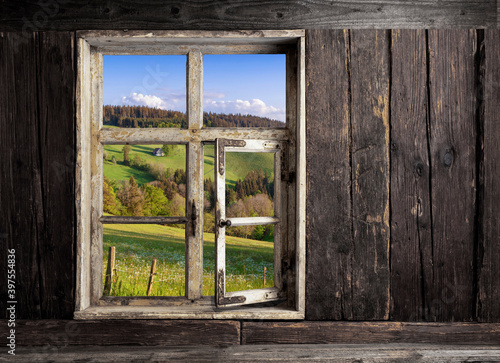 view through a wooden window into the landscape