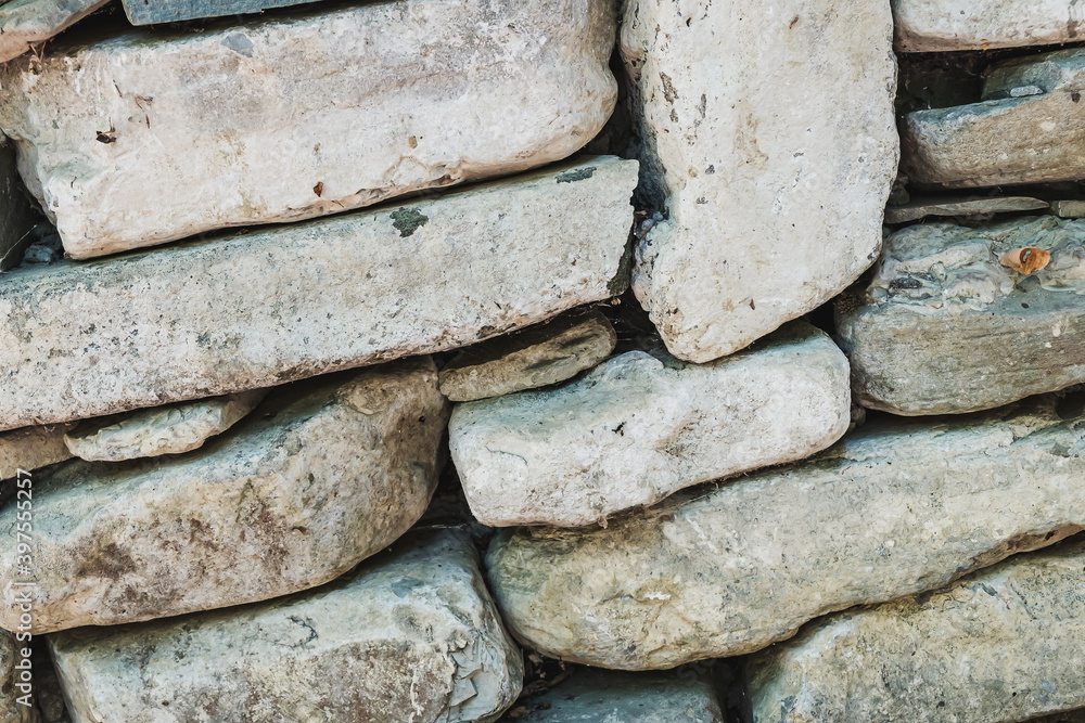 The ancient rusty old masonry stone texture for background and design concepts. the shadow. geology. The ancient rusty old masonry stone texture for background and design concepts. the shadow. geology.
