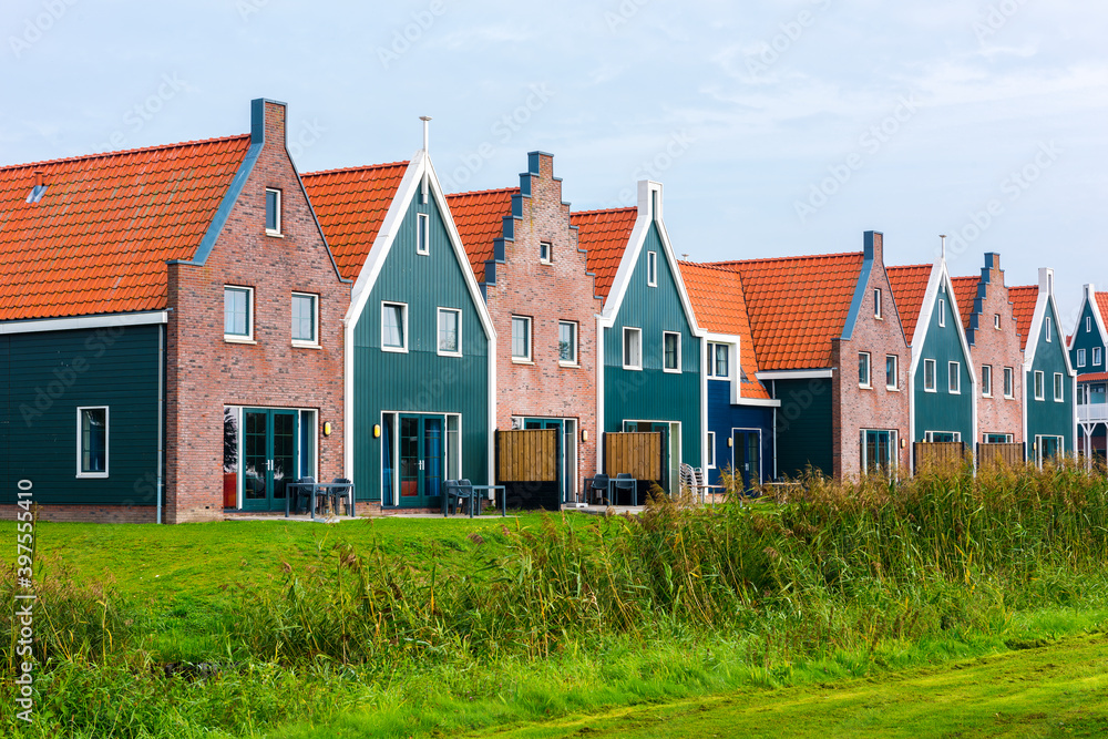 Volendam is a town in North Holland in the Netherlands. Colored houses of marine park in Volendam. Volendam is a town in North Holland in the Netherlands. Colored houses of marine park in Volendam.