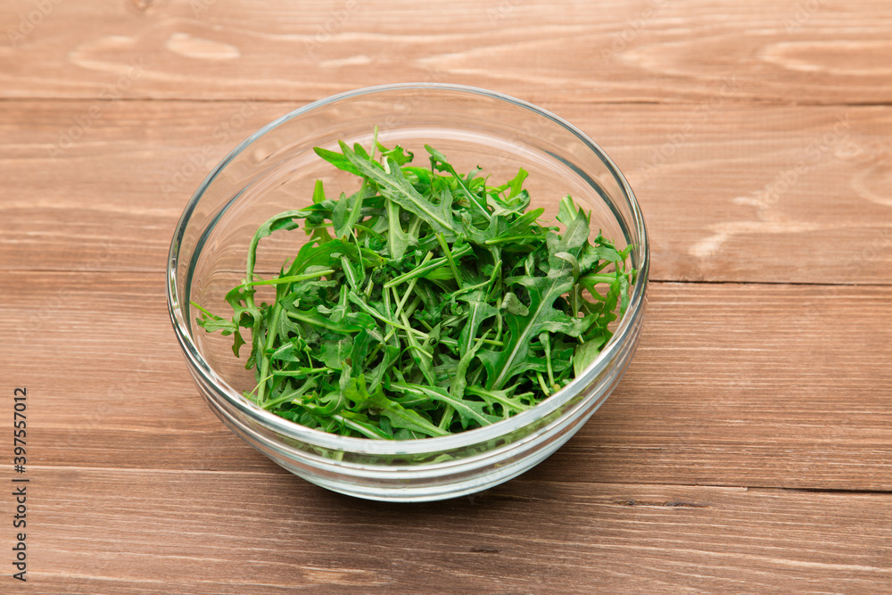 Fresh green arugula leaves in a glass bowl Fresh green arugula leaves in a glass bowl