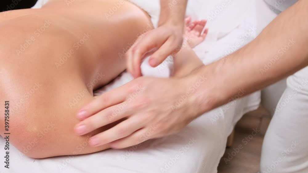 Massage therapy relax and body care treatment concept. Woman lying on the bed with towel with masseur massaging hands relaxation in spa salon. Massage therapy relax and body care treatment concept. Woman lying on the bed with towel with masseur massaging hands relaxation in spa salon.