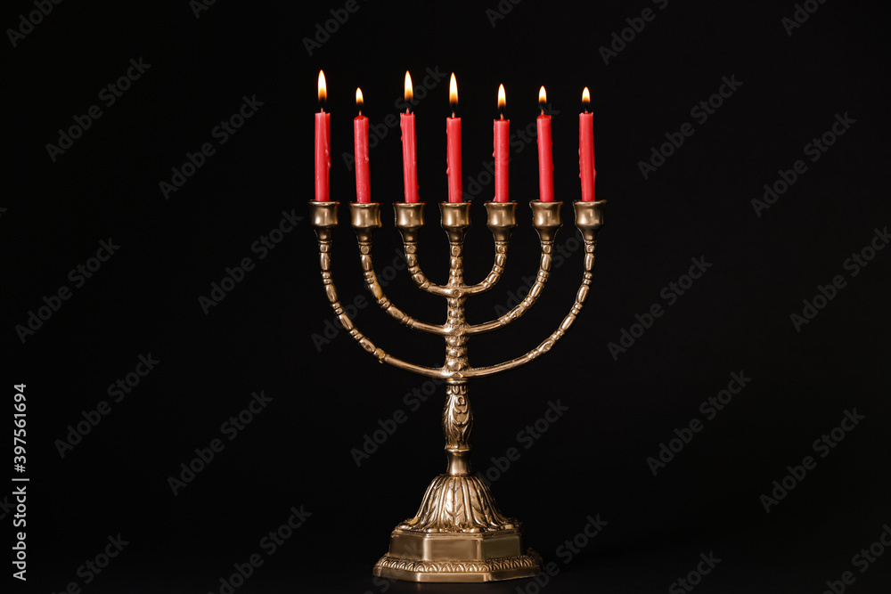 Fototapeta premium Golden menorah with burning candles on black background