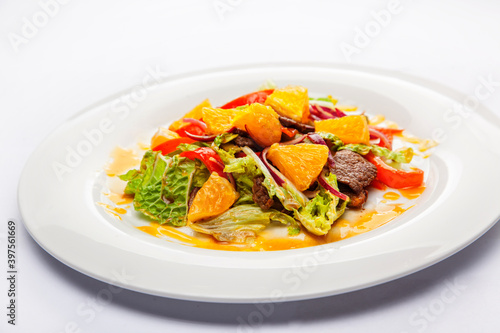 Warm salad from veal, orange and green