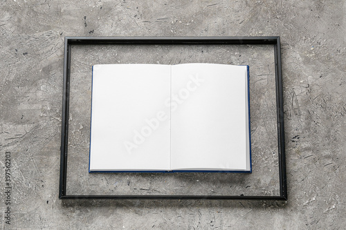 Blank book with frame on grunge background