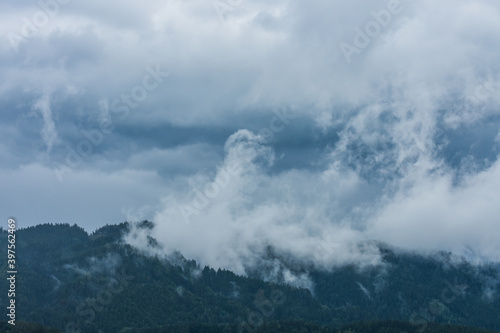landscape with rain and rising clouds of fog