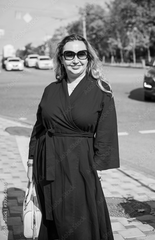 Beautiful woman on a walk in the city. Autumn- Winter time. A nice middle aged plus size woman at the street. Citizen lifestyle Beautiful woman on a walk in the city. Autumn- Winter time. A nice middle aged plus size woman at the street. Citizen lifestyle