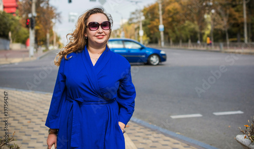 Beautiful woman on a walk in the city. Autumn- Winter time. A nice middle aged plus size woman at the street. Citizen lifestyle © T.Den_Team