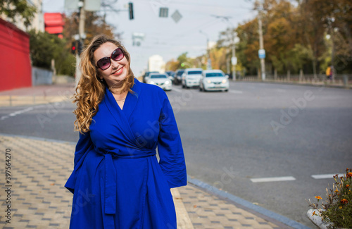 Beautiful woman on a walk in the city. Autumn- Winter time. A nice middle aged plus size woman at the street. Citizen lifestyle