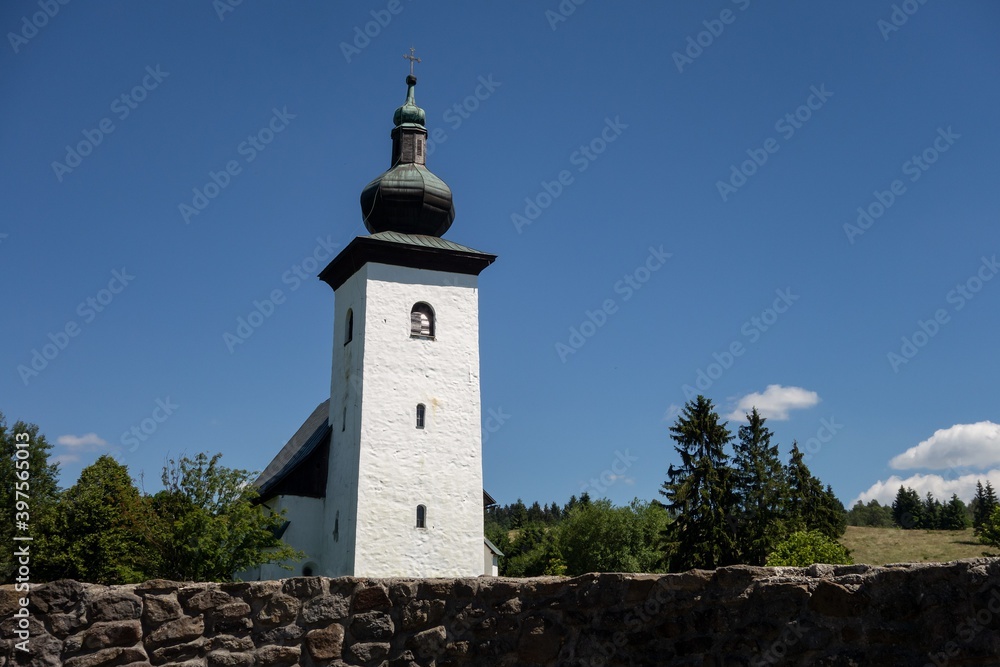 Geographical Centre of Europe (Geograficky stred Europy) near Kremnica and Kremnicke Bane, Slovakia with church tower