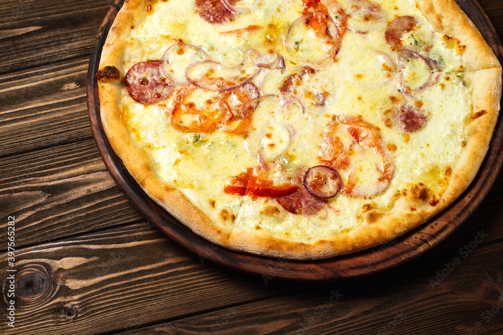 Pizza on a dark brown wooden table background