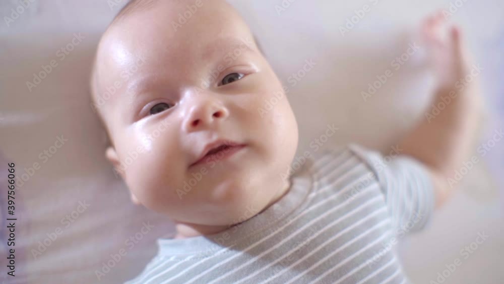 Nice Little Baby Lying in the Crib, Close-up of the Emotional Face of a Child Nice Little Baby Lying in the Crib, Close-up of the Emotional Face of a Child