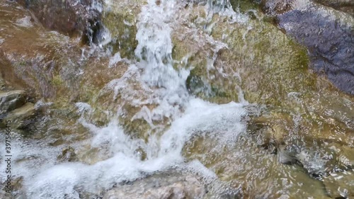 Mountain river in the spring forest. The purest cool water flows quickly from the mountains. River Bufile Dere Yalta Crimea at the Botkin path. Rapid mountain stream. Hiking in the forest. photo