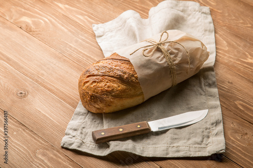 Fresh loaf of bread and a butter knife