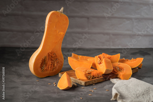 Selective focus shot of Butternut squash sliced on a cutting board
