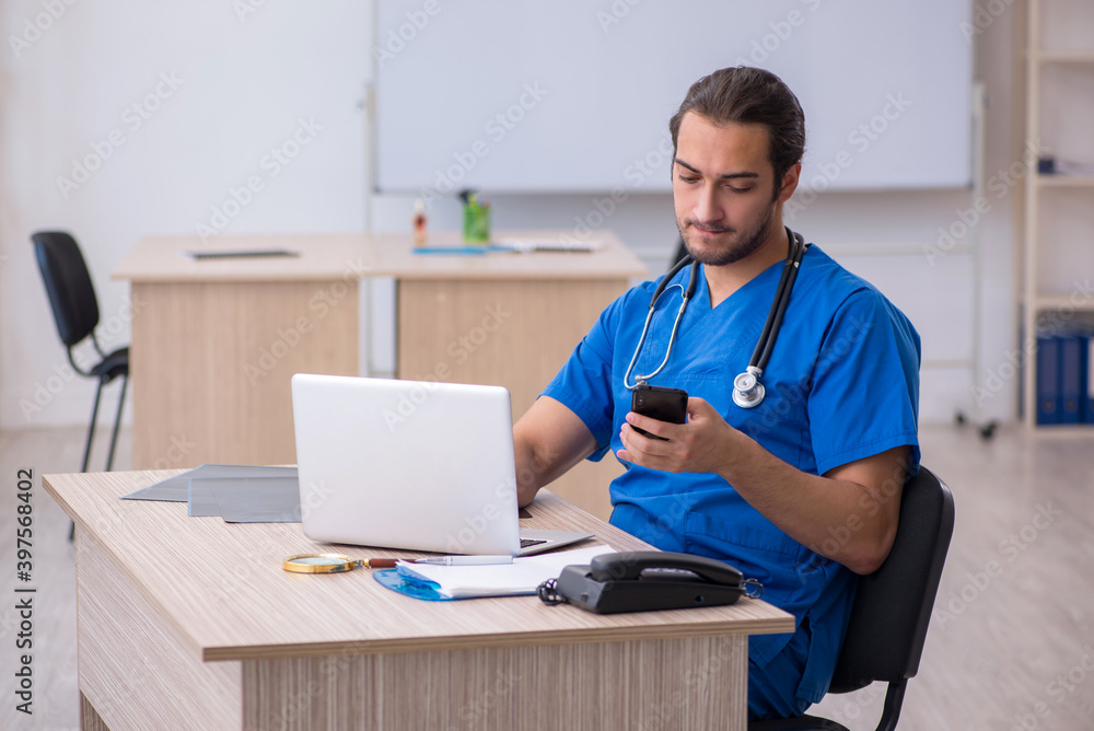 Young male doctor working in the clinic Young male doctor working in the clinic