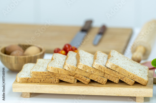 Slice of Whole wheat bread on a wooden plate in the kitchen