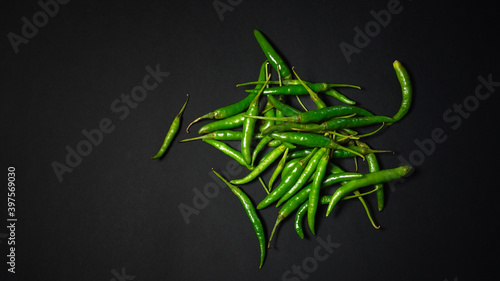 Spicy Green chilies on black background.