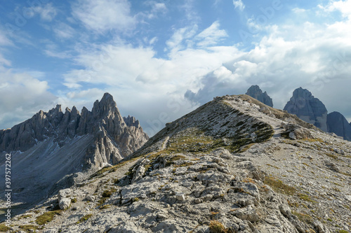 A panoramic view on Toblinger Knoten and surrounding mountains in Italian Dolomites. Difficult ad dangerous climbing route. Stony valley below. Few narrow pathways on the side. Freedom and serenity