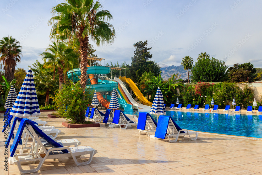 Swimming pool with water slide at the tropic summer resort