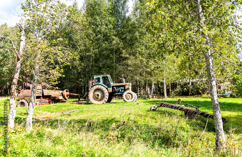 Old agricultural machinery with wheeled tractor and other equipment