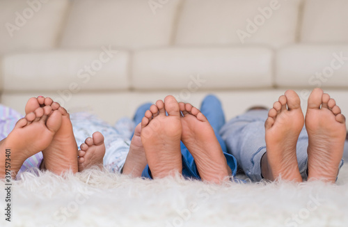 Bare Feet in a Row. Family Children Feets on Fluffy Bed