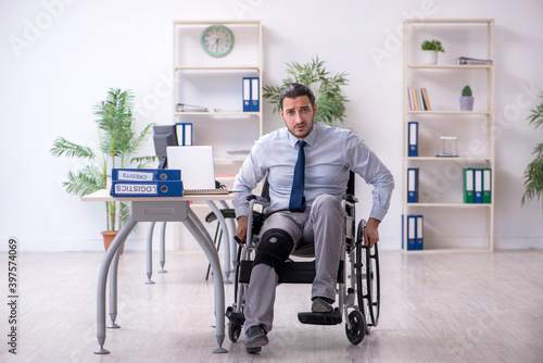 Young leg injured employee working in the office