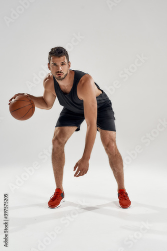 Young muscular caucasian basketball player leading ball © Svitlana
