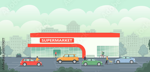 Supermarket building in the background of the city. Large grocery store with parking and cars. People shop for goods