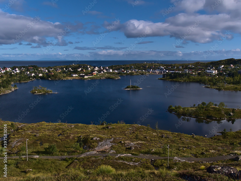 Beautiful panoramic view over Sørvågvatnet lake and fishing village Sørvågen located on coast of Norwegian Sea on Moskenesøy island, Lofoten, Norway on sunny day in late summer.