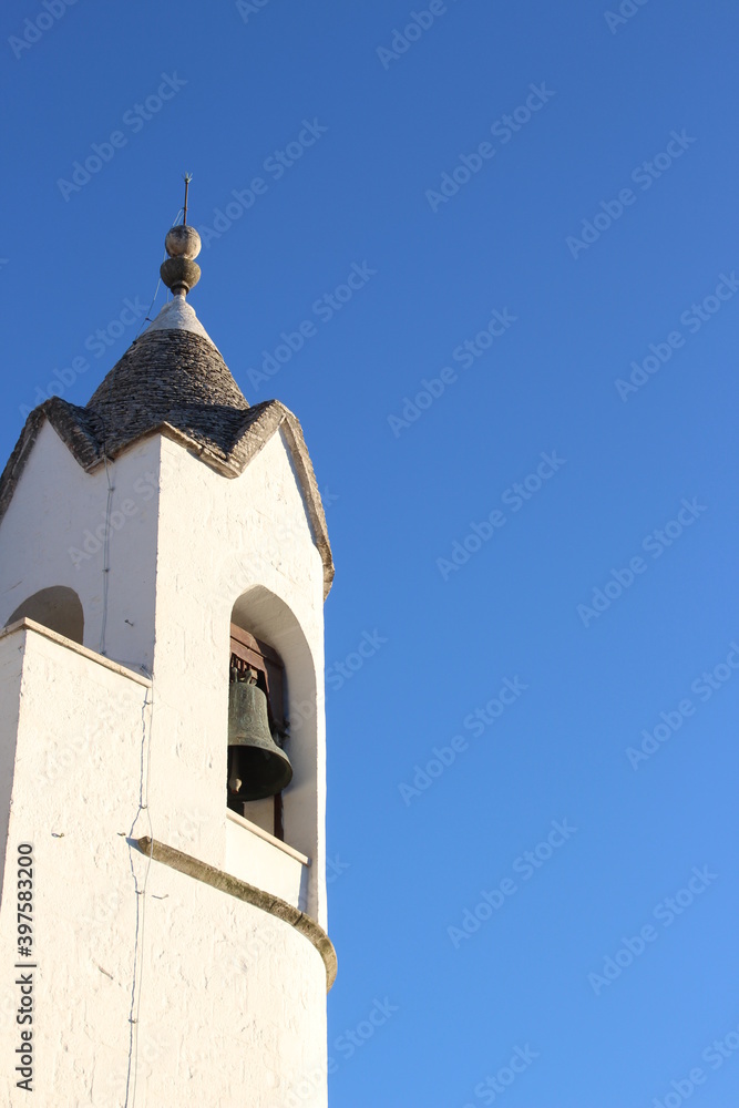 White cathedral tower in Alberobello, Italy