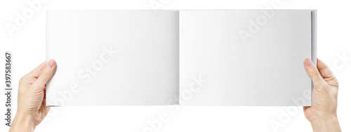 Hands holding open wide album, isolated on white background