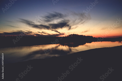 Dicey ducks floating on the lake at sunset in autumn