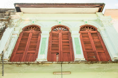 colorful shutters on the Windows of the old town in Phuket in Thailand