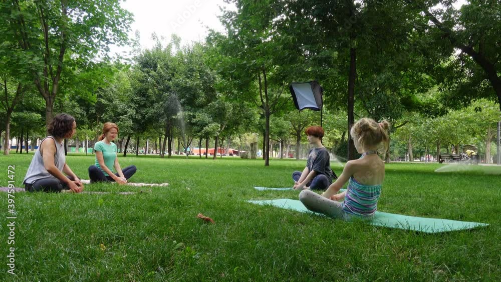 group of girls practicing yoga exercises outdoors
group of girls practicing yoga exercises outdoors