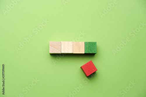 Fototapeta Naklejka Na Ścianę i Meble -  A wooden cube on green backgroud, business, finance and education concept