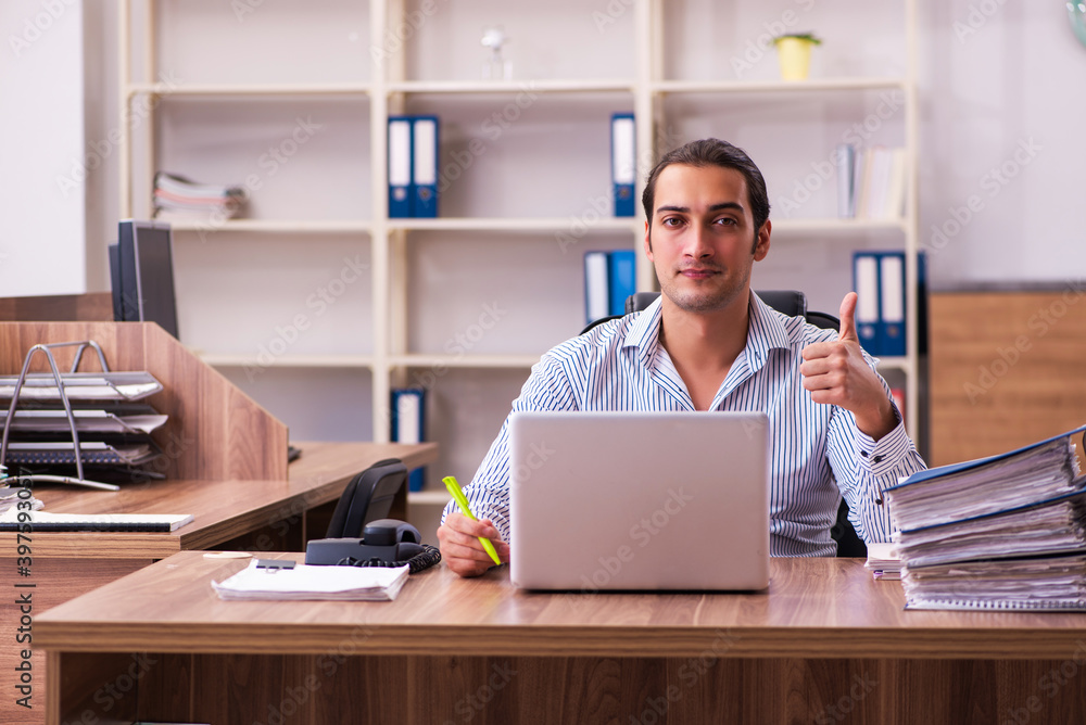 Young male employee working in the office Young male employee working in the office