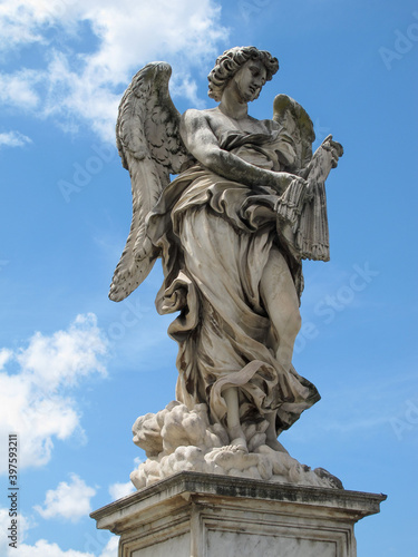A statue of a winged angel on Saint Angel bridge in Rome  Italy  which is also known as Ponte Sant Angelo.  Image has copy space.