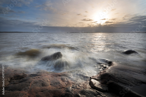 Sea landscape. Sunset in Finland coast rocks and waves.