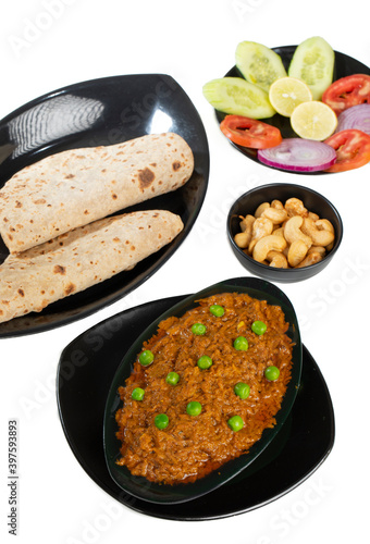 Rajasthani Famous Traditional Cuisine Haldi Sabji or Tukkar Served with Salad on White Background