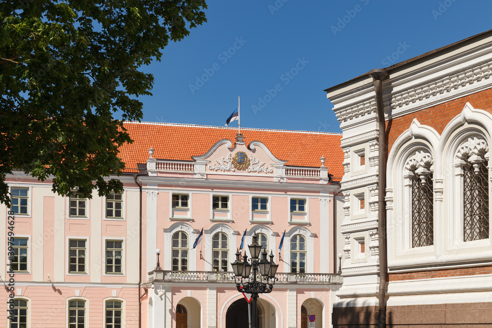 TALLINN, ESTONIA - MAY 29, 2020: Old town street view. Sunny summer day. Vintage lantern and Parliament building at the background