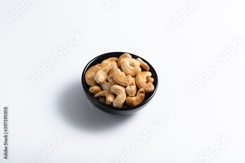 Cashew nut in container with white background