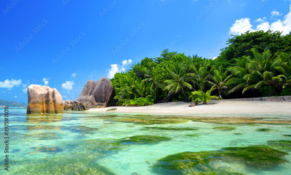 Beatiful beach Anse Source d'Argent with big granite rocks in sunny day. La Digue Island, Seychelles. Tropical destination.
